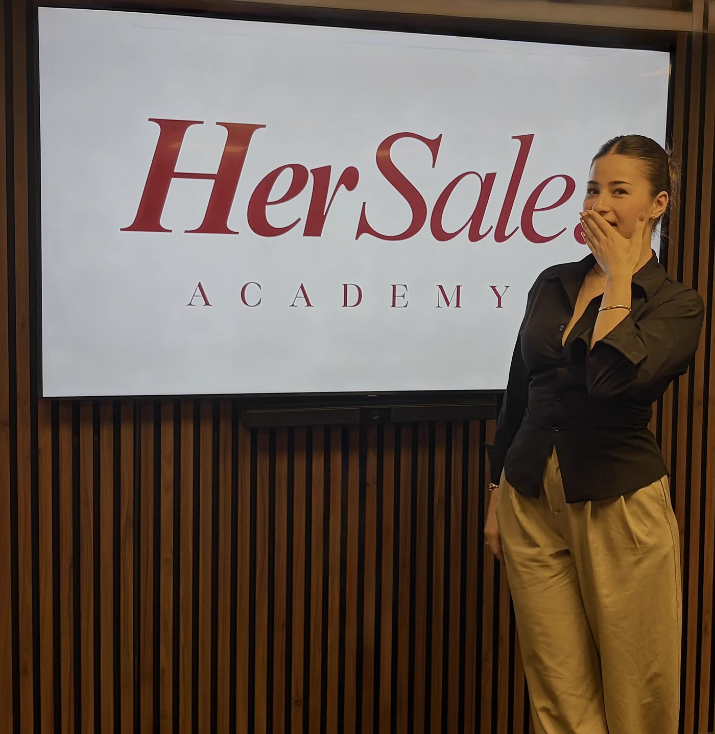 Yasemin Gultekin in front of the HerSale Academy wordmark